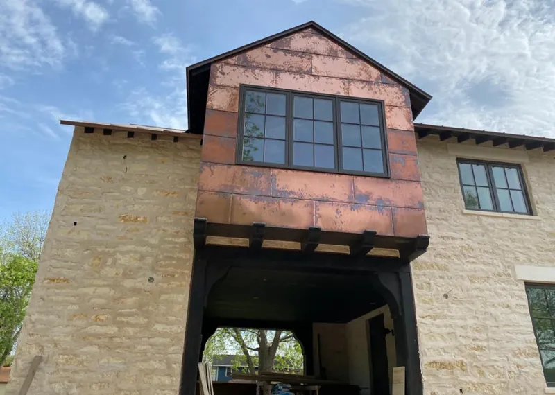 Copper metal panel facade on a stone building for Roof Repair in Wasco